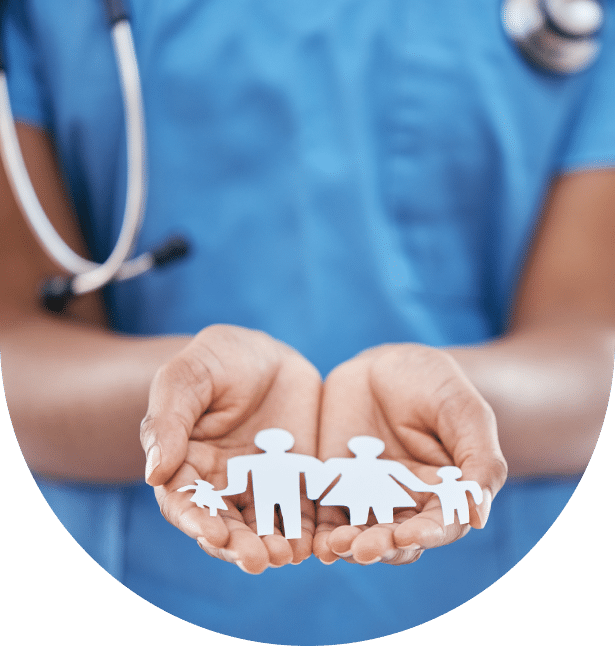 A healthcare professional wearing scrubs and a stethoscope holds paper cutouts of a family in their hands, symbolizing medical care and family health, making it an ideal visual for a landing page.
