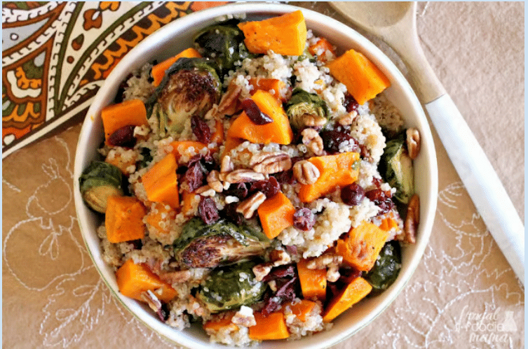 Embrace the season with a bowl of quinoa salad, featuring roasted Brussels sprouts, sweet potatoes, cranberries, and pecans for a perfect blend of seasonal nutrition.